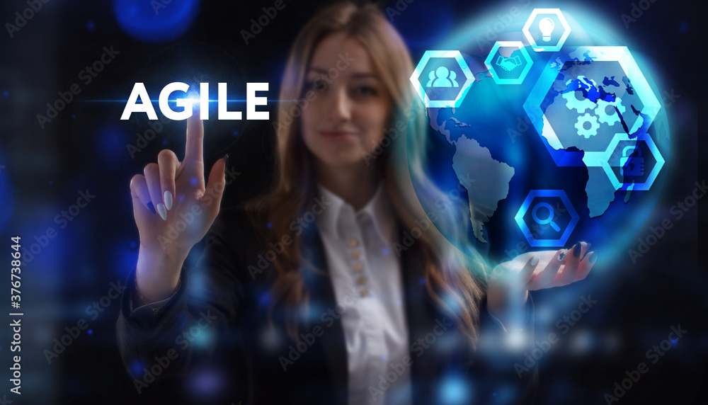 Business, Technology, Internet and network concept. Young businessman working on a virtual screen of the future and sees the inscription: Agile Business, Technology, Internet and network concept. Young businessman working on a virtual screen of the future and sees the inscription: Agile
