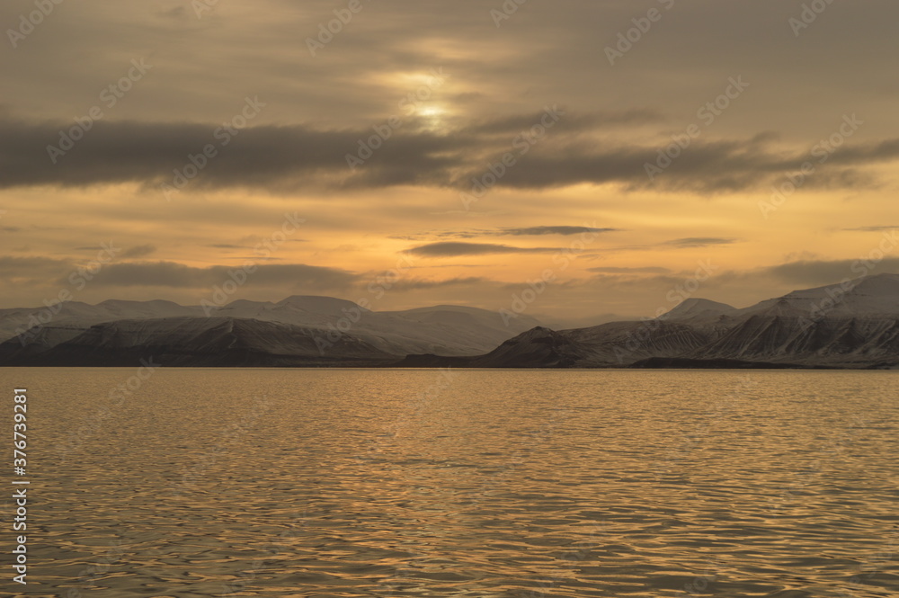 Winter sunset in the ice fjords of the Norwegian Archipelago of Svalbard (Spitsbergen), Norway Winter sunset in the ice fjords of the Norwegian Archipelago of Svalbard (Spitsbergen), Norway