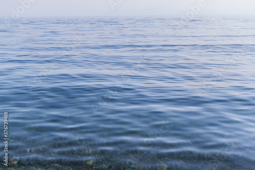 clear calm blue water surface of lake baikal, ripples, morning, light summer