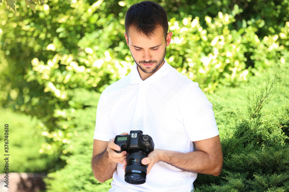Young photographer with camera in the park Young photographer with camera in the park