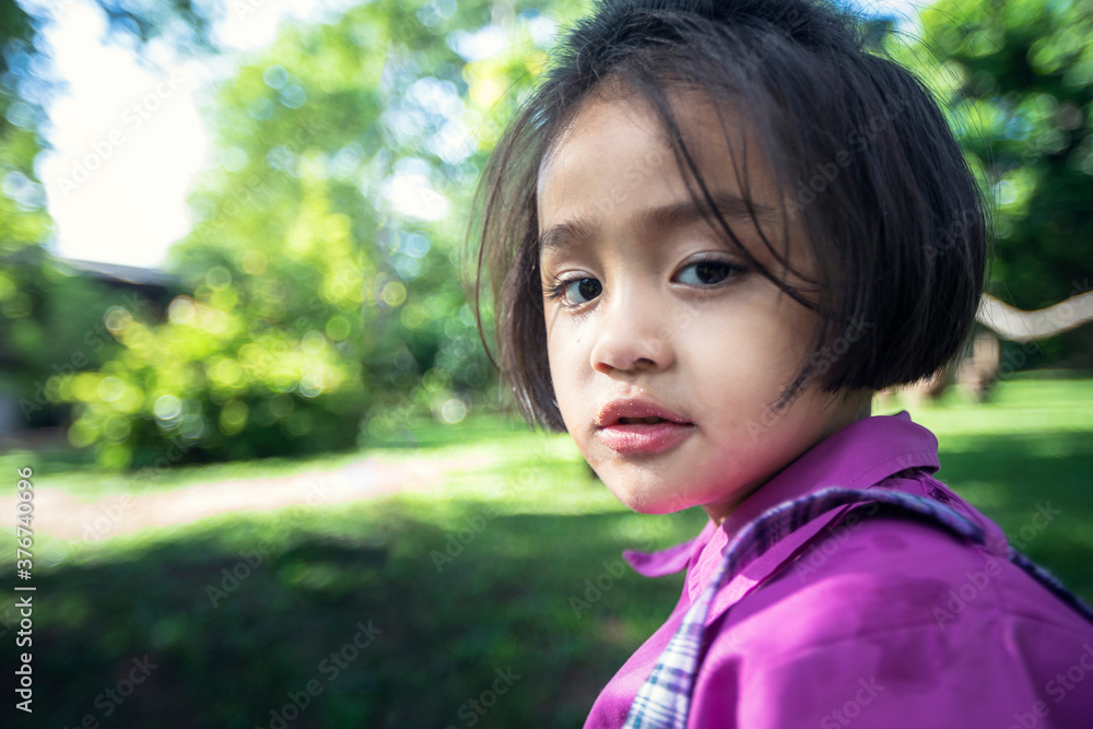 Cute little girl is learning outside the classroom happily with beautiful nature And a bright smile Cute little girl is learning outside the classroom happily with beautiful nature And a bright smile