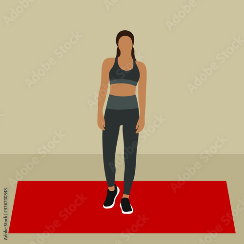 Woman stands on fitness mat in sportswear