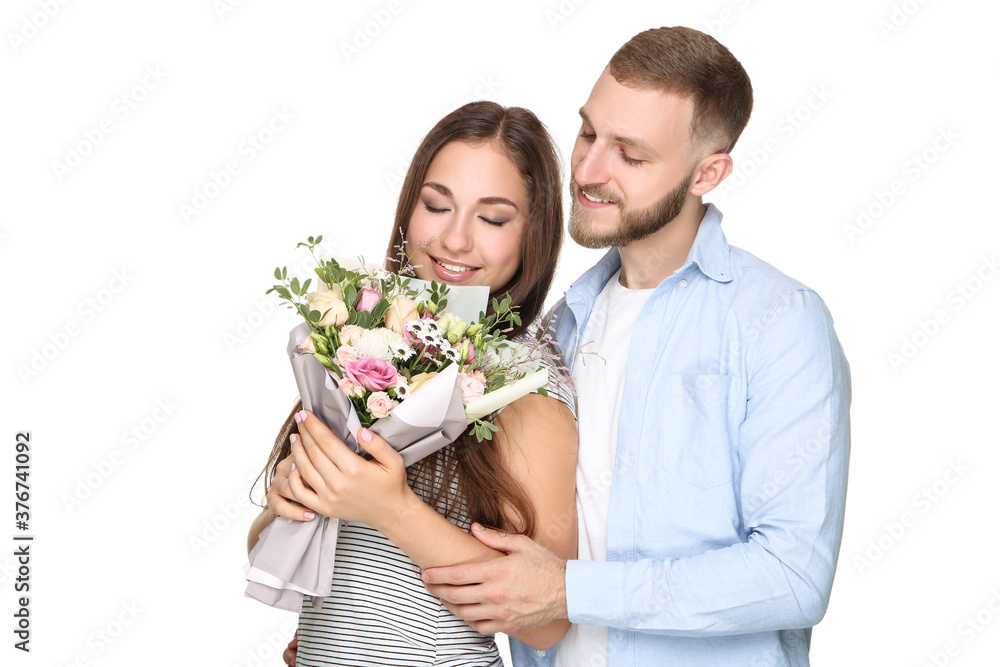 Happy young couple with bouquet of flowers on white background Happy young couple with bouquet of flowers on white background