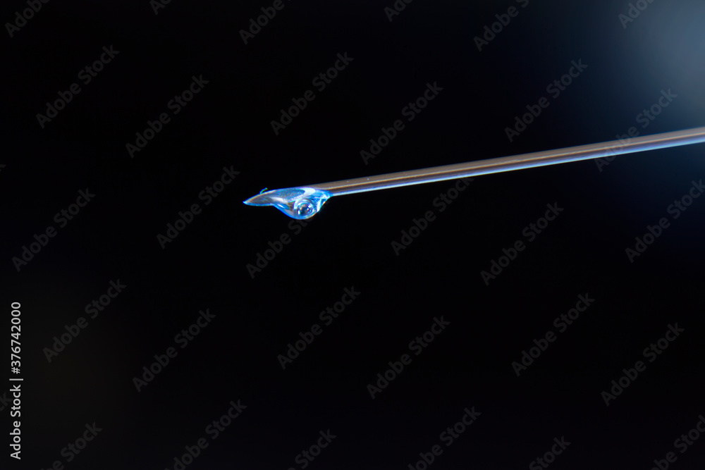 detail of syringe needle with a drop of medicine detail of syringe needle with a drop of medicine