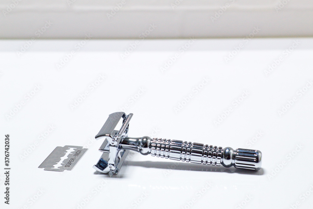 Traditional razor on white background in bathroom Traditional razor on white background in bathroom
