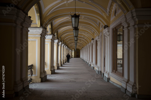 Lonely man walking in Saint Petersburg gallery, Russia.
