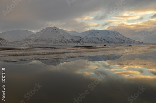 Sunset reflections over the frozen Arctic Norwegian Archepelago of Svalbard, Norway © ChrisOvergaard