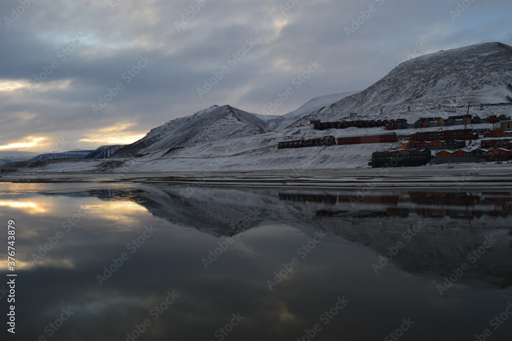 Sunset reflections over the frozen Arctic Norwegian Archepelago of Svalbard, Norway