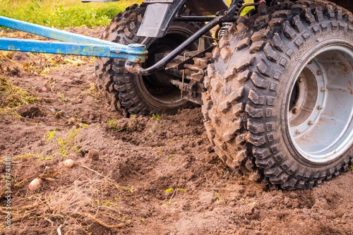 ATV wheels with a hitch on the background of the ground in the field