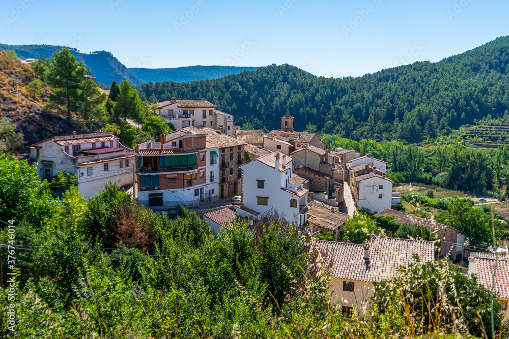 View of a beautiful rural town located on the side of a mountain surrounded by a lot of very green vegetation. Selective focus
