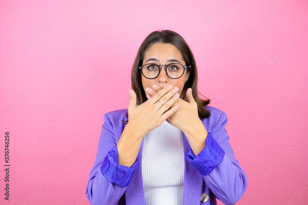 Young beautiful business woman over isolated pink background shocked covering mouth with hands for mistake. Secret concept. Young beautiful business woman over isolated pink background shocked covering mouth with hands for mistake. Secret concept.