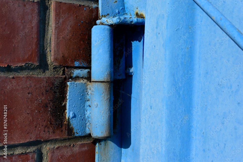 Hinged iron hinges on garage doors in blue Hinged iron hinges on garage doors in blue