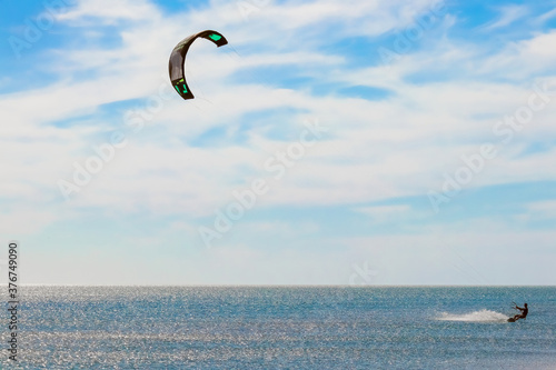 Canvas Print a kitesurfer surfing on the smooth azure water