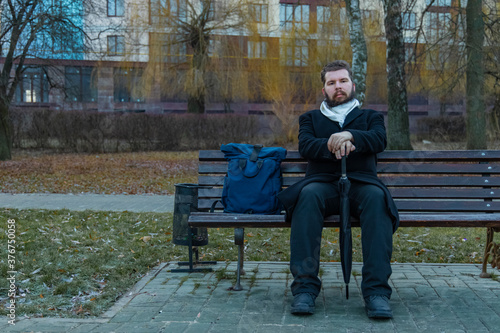 Bilde på lerret middle adult calm bearded man sitting on bench lonely melancholy mood in autumn