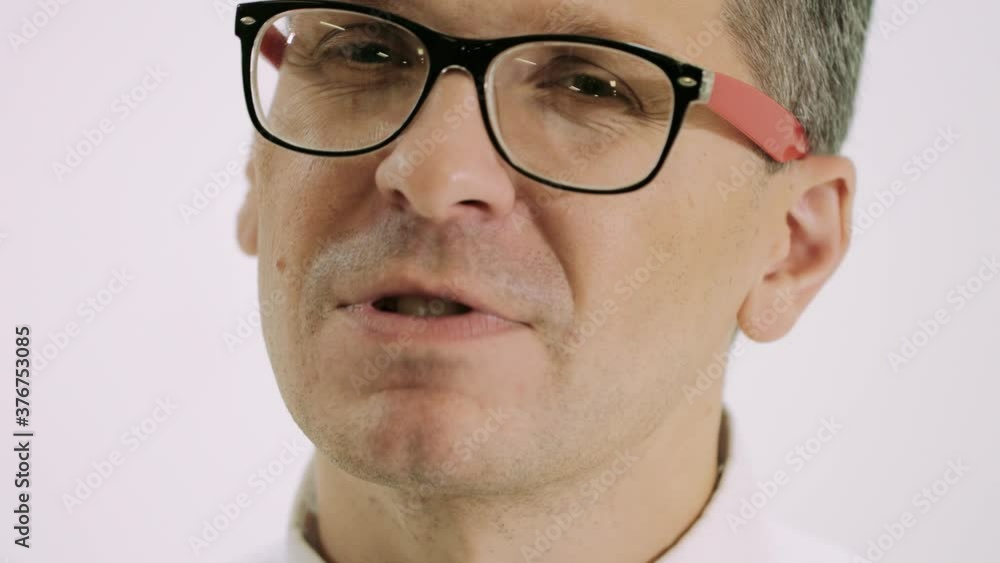 Man emotionally and gesticulating sings a song in the home. Man in glasses Man emotionally and gesticulating sings a song in the home. Man in glasses