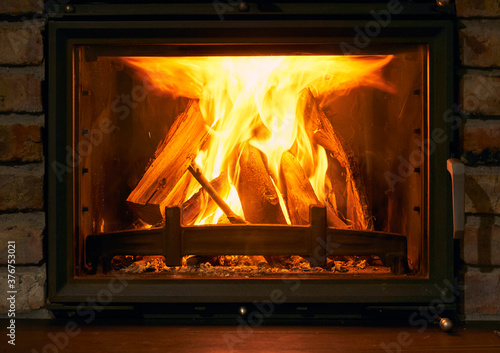 fireplace and fire close view as object or background  brick wall