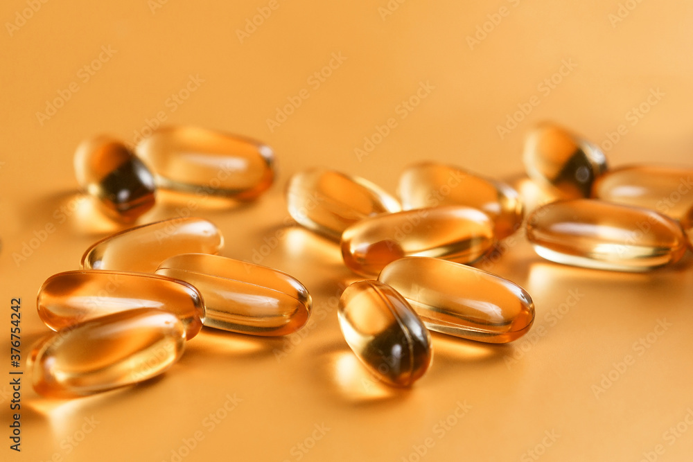 Many capsules Omega 3 on yellow background. Close up, high resolution product. Health care concept. Many capsules Omega 3 on yellow background. Close up, high resolution product. Health care concept.