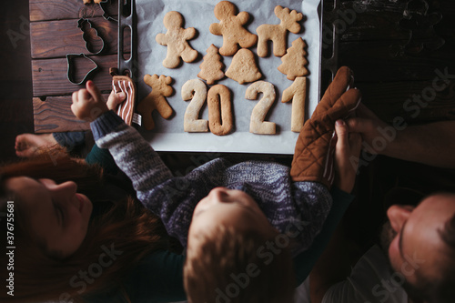 Little boy and parents with gingerbread cookies