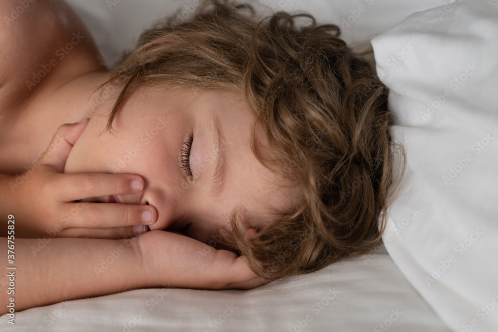 Adorable kids sleeping in bed at home. Healthy peaceful sleep. Adorable kids sleeping in bed at home. Healthy peaceful sleep.
