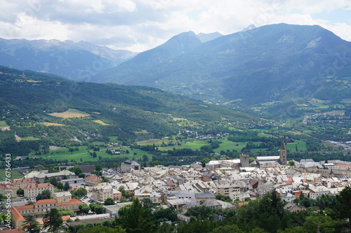view of the town of Embrun, France from above with the valley and mountains © poupine