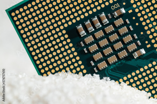 Close-up macro of a CPU unit processor on silica sand