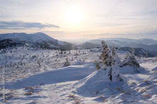 Beautiful winter mountain views at sunset during a snowshoe hike along the red ridge trail in the Low Tatras, Slovakia - around Sedlo pod Skalkou