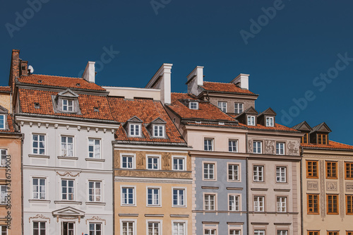 old historic tenement houses against the blue sky in the old town square in Warsaw  Poland