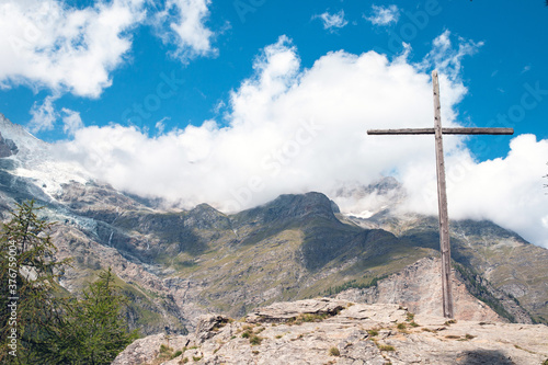 Alpine Cross. An alpine landscape containing a large wooden cross. Beautiful mountain landscape in Austria with blue sky