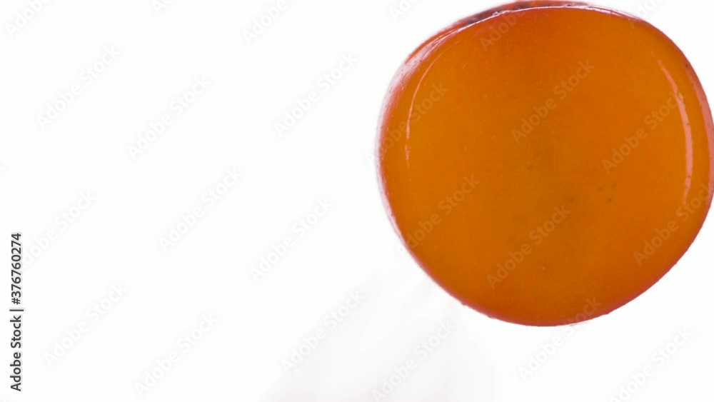 Crush the Ripe Sea Buckthorn Berry. Wild sea buckthorn berries are compressed and crushed close-up on a bright white background, creating a juicy burst of pulp and shell. Shooting at 120fps Crush the Ripe Sea Buckthorn Berry. Wild sea buckthorn berries are compressed and crushed close-up on a bright white background, creating a juicy burst of pulp and shell. Shooting at 120fps