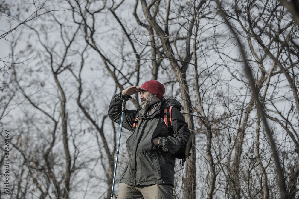Man with backpack traveling alone in the forest Man with backpack traveling alone in the forest