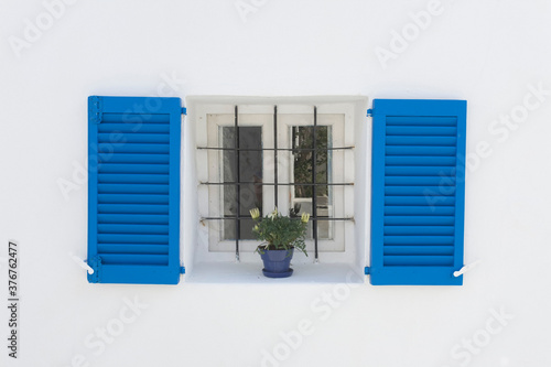 Colorful shutters and flowers in window photo