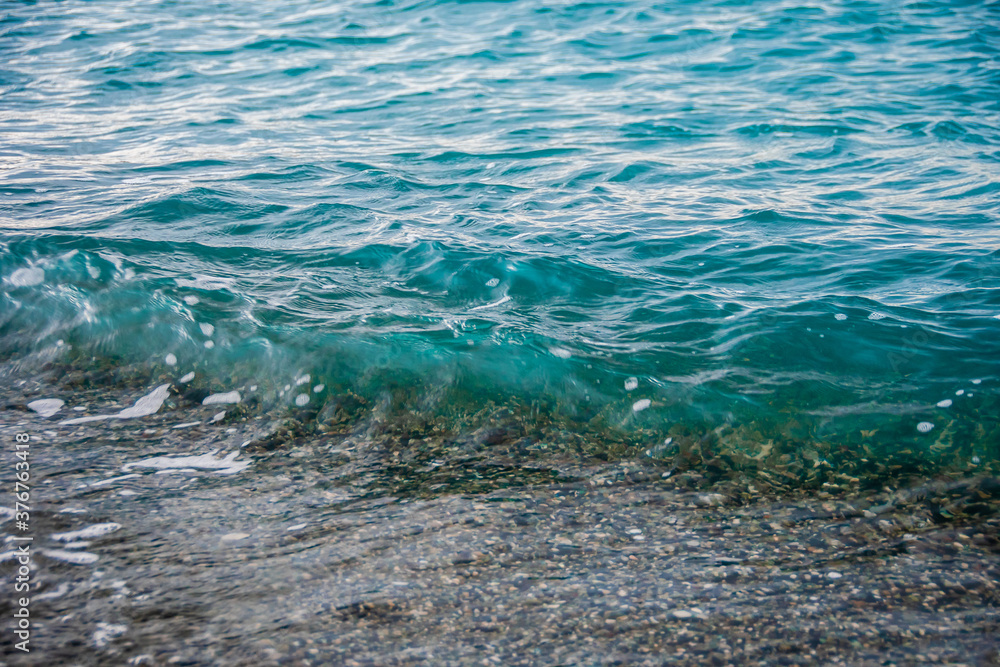 Sea tide on a pebble shore. Waves on a pebble beach. Clear sea water. Nature concept, background. Sea tide on a pebble shore. Waves on a pebble beach. Clear sea water. Nature concept, background.