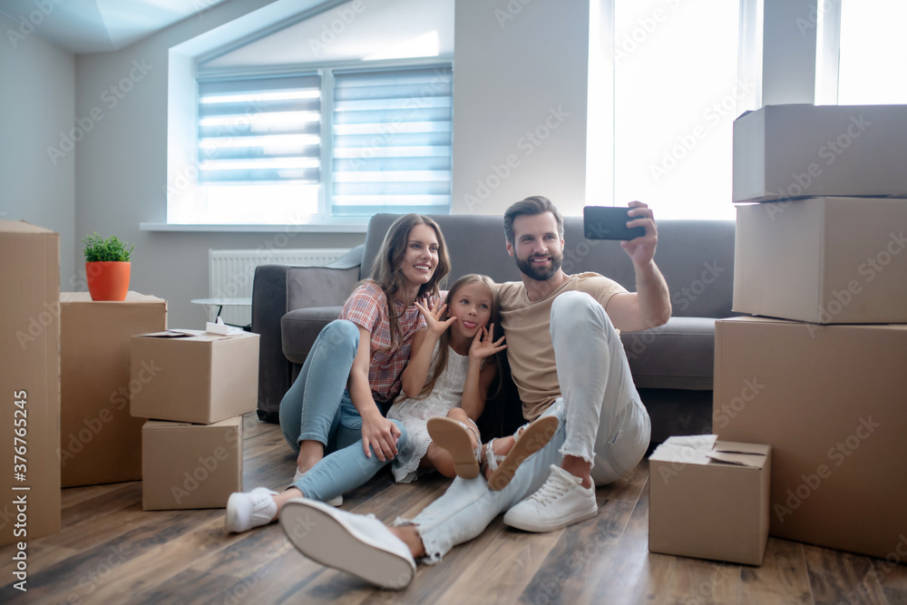Happy family making photo and looking contented Happy family making photo and looking contented