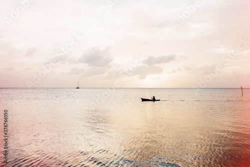 Lone boatman, Caye Caulker, Belize photo