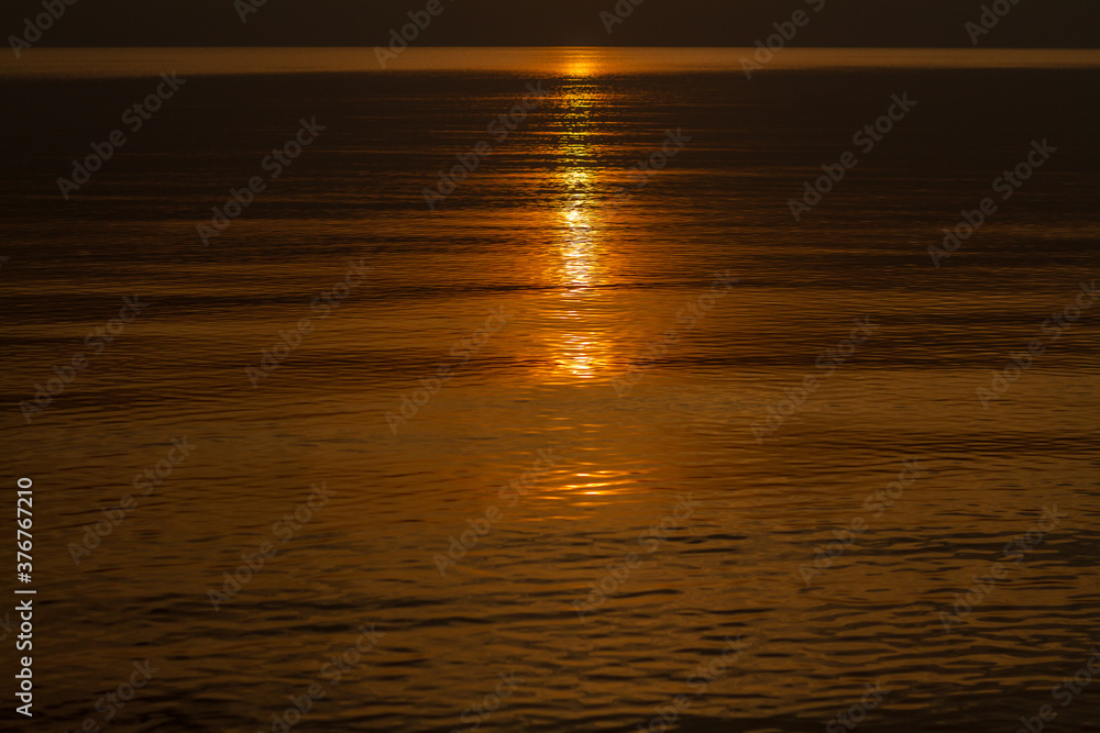 Sun trail in water during sunset