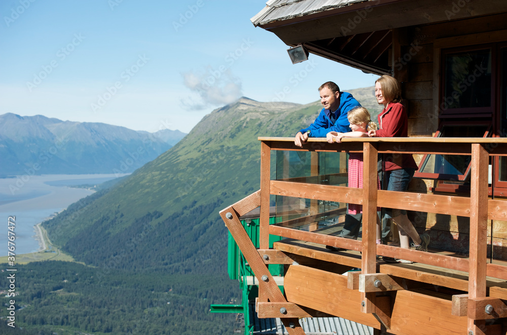 Father and daughters enjoying view of Mt. Alyeska, Girdwood, Alaska, USA Father and daughters enjoying view of Mt. Alyeska, Girdwood, Alaska, USA