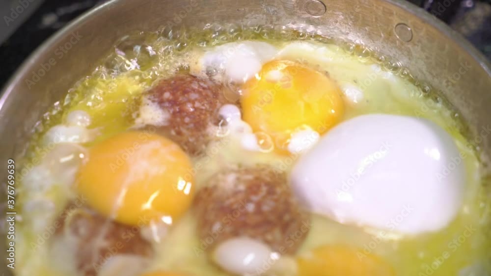 Top view of Turkish sausage with egg is cooking in pan on stove. Top view of Turkish sausage with egg is cooking in pan on stove.