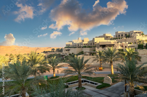 Palm trees in garden of Qsar Al Sarab desert resort, Empty Quarter Desert, Abu Dhabi, United Arab Emirate photo