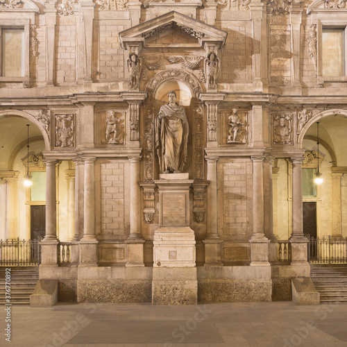 Statue of Saint Ambrose (Aurelius Ambrosius), Bishop of Milan in 374 AD outside the Palazzo Giureconsulti, Milan, Italy photo