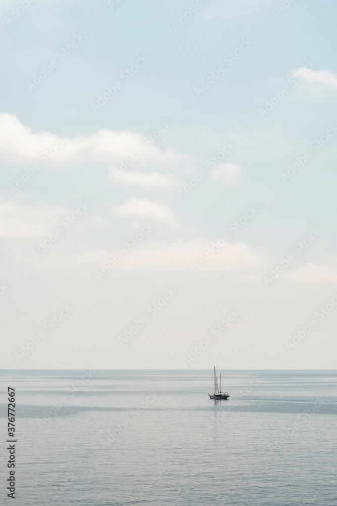 Sailboat anchored in calm sea Sailboat anchored in calm sea