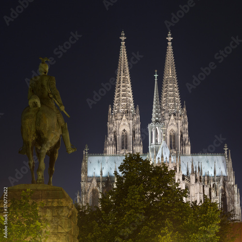 Kaiser Wilhelm II statue and Cologne Cathedral (Koelner Dom) at night, Cologne, Germany photo