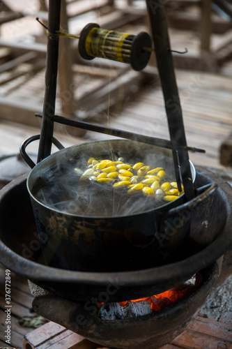 Silkworm cocoons (Bombyx mori) in steaming saucepan, Phnom Penh, Cambodia photo