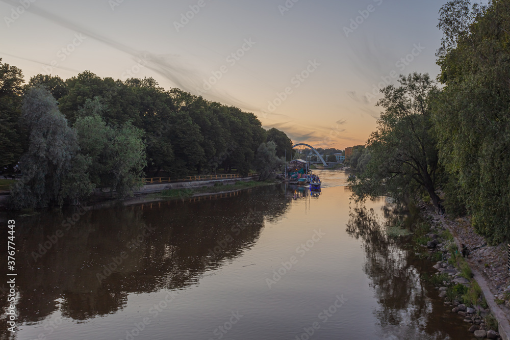 Tartu, Estonia, 01 August 2020 Panorama of the Ema River and the embankment summer evening, white nights in the Baltic countries. Tartu, Estonia, 01 August 2020 Panorama of the Ema River and the embankment summer evening, white nights in the Baltic countries.