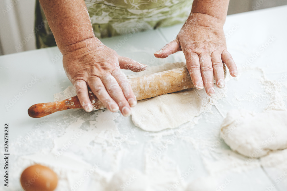 Woman kneading dough at home kitchen