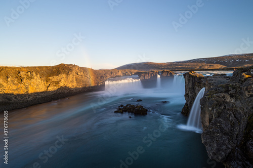 Long exposure shot of a rainbow hitting the Godafoss (Waterfall of the gods) in Iceland.