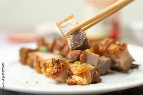 Oriental roast pork belly or char siew on white plate photo