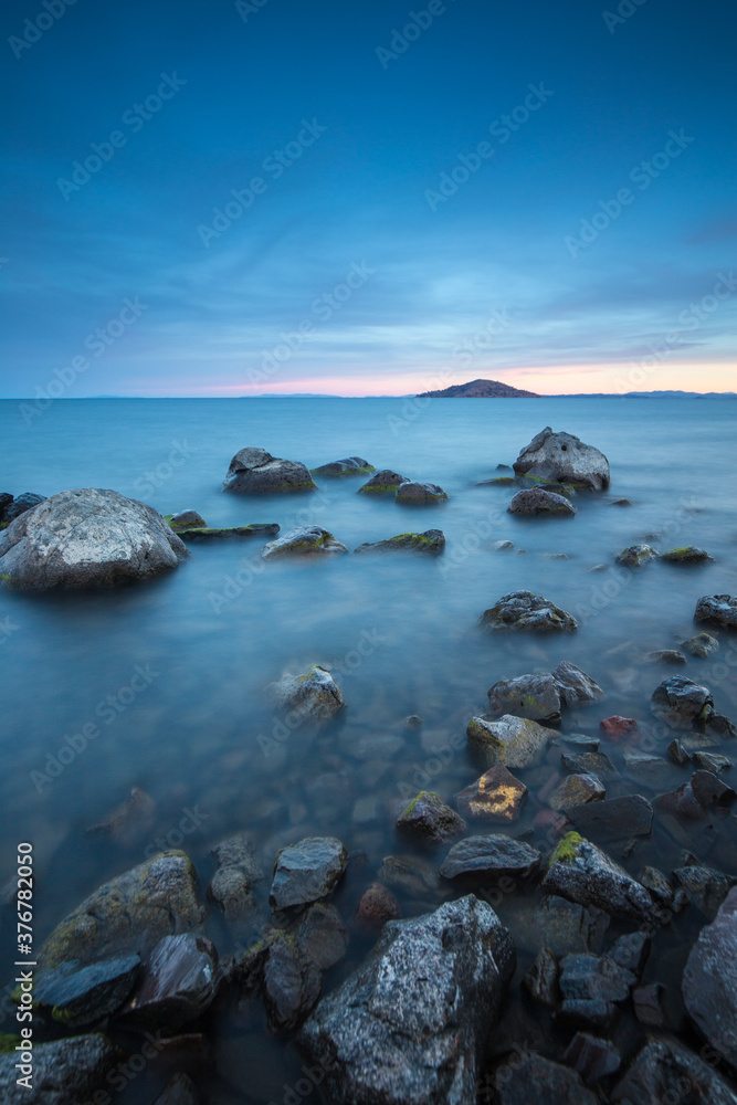 Scenic view of Lake Titicaca against cloudy sky Scenic view of Lake Titicaca against cloudy sky