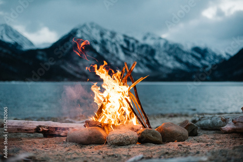 View of campfire burning by lake photo