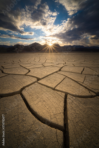 View of cracked desert landscape during sunrise