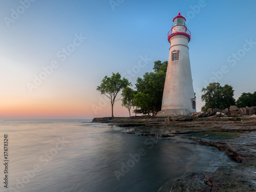 View of Marblehead Lighthouse against blue sky during sunrise photo